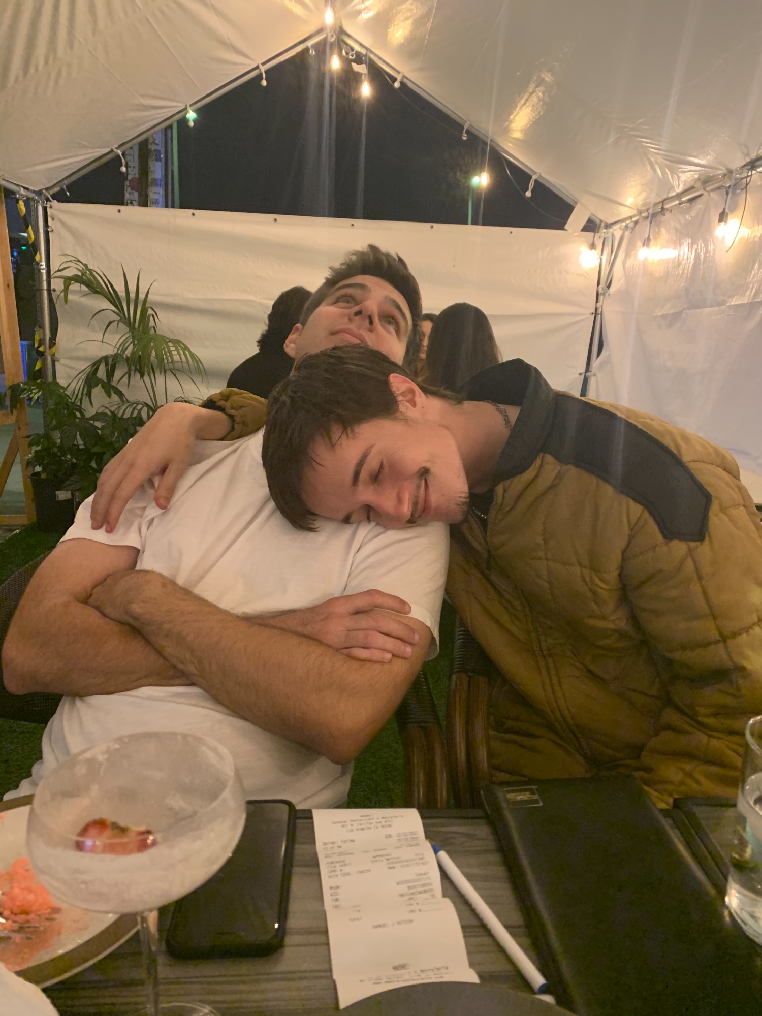 An arm around me at a table, late at night