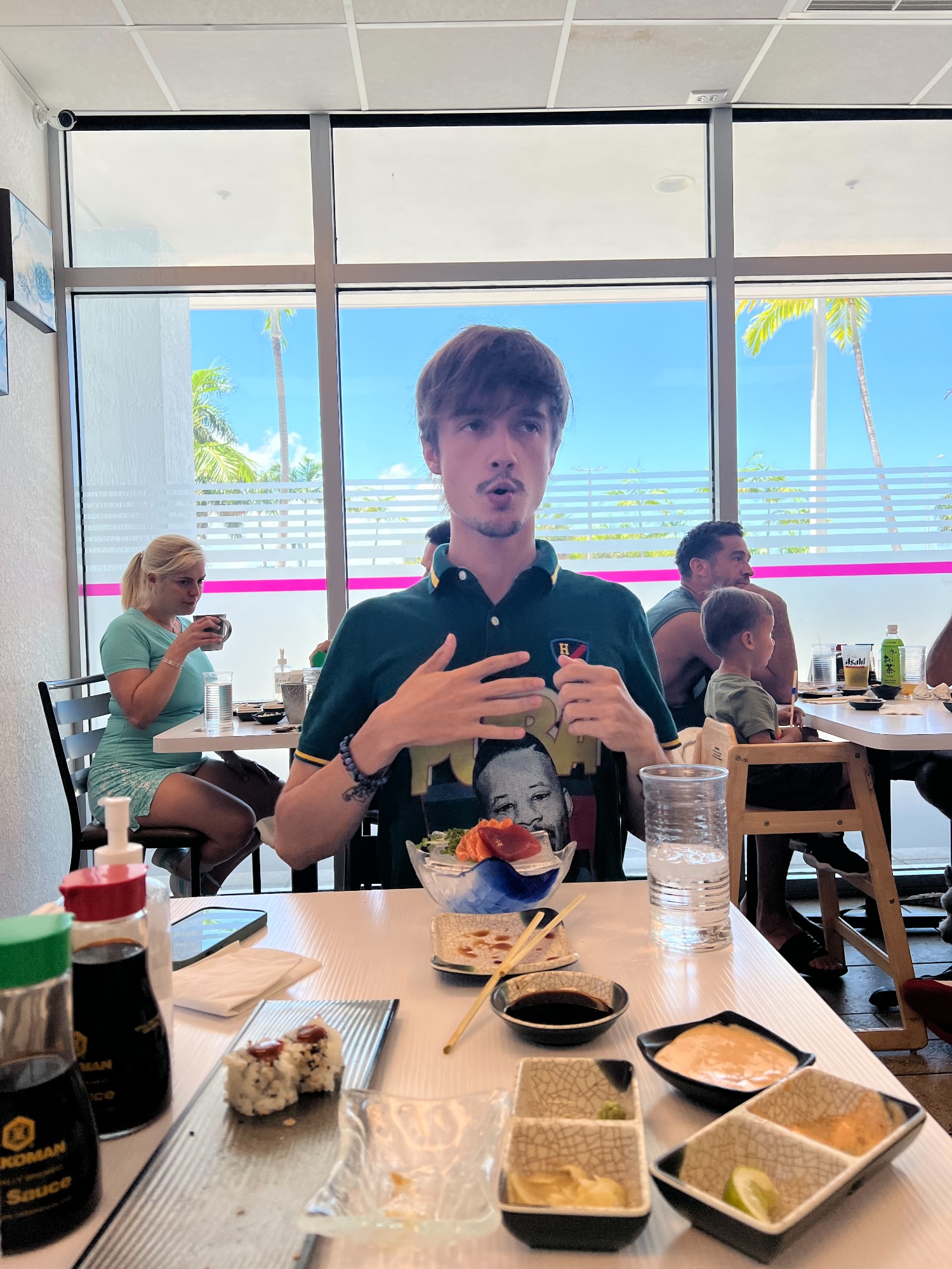 Johnny mid-sentence over lunch, hands going